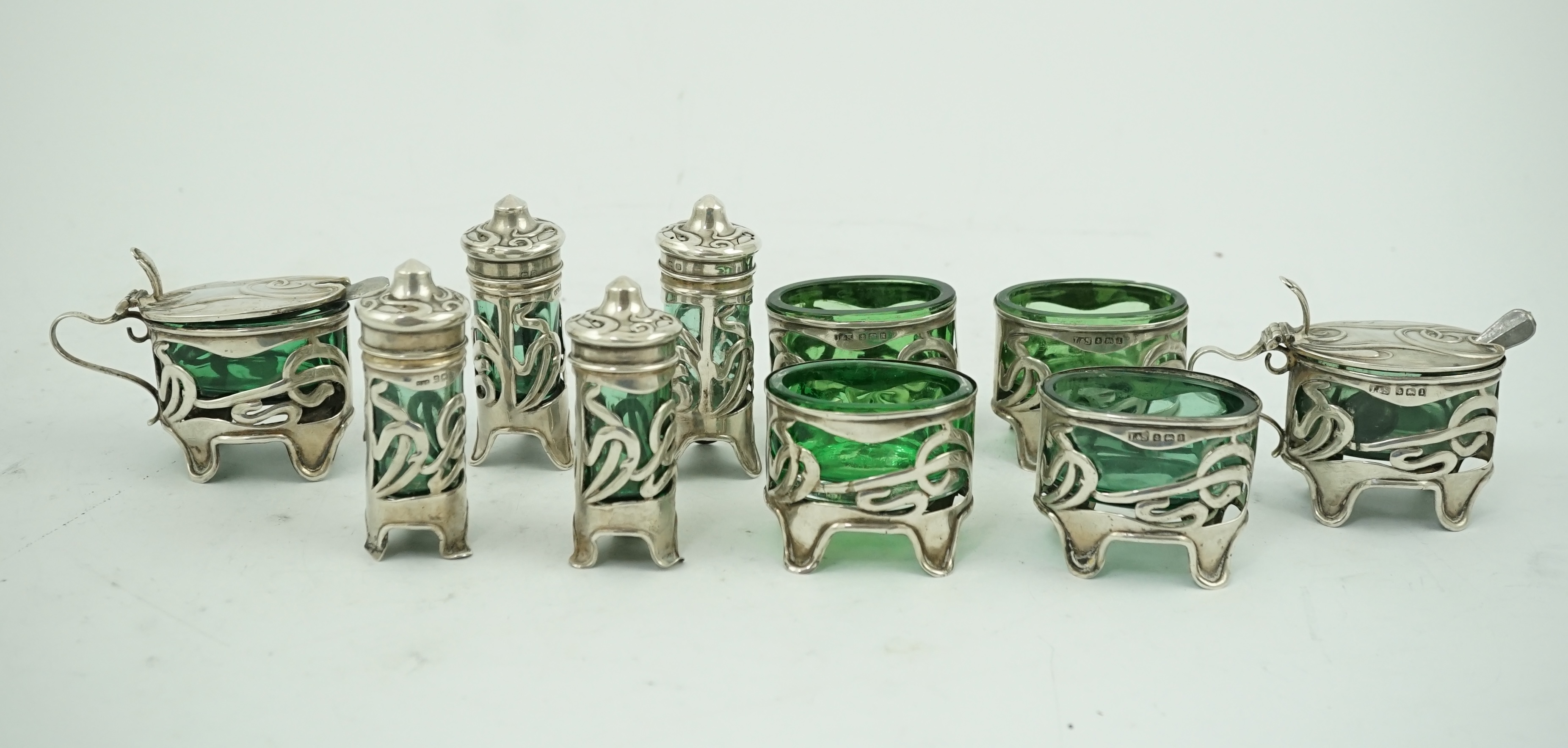 An early 20th century Art Nouveau pierced silver ten piece condiment set by Levy & Salaman